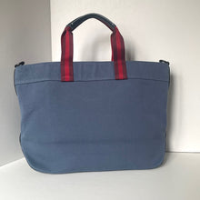 Load image into Gallery viewer, Blue bag with red handles on a white background