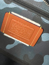 Load image into Gallery viewer, Close-up of a brown leather label on a textured surface
