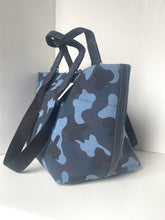 Load image into Gallery viewer, Blue camouflage-patterned bag with black straps on a white background