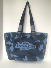 Load image into Gallery viewer, Blue camouflage Coach bag with black handles on a white background