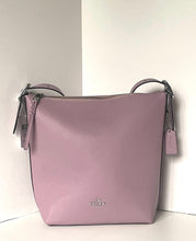 Load image into Gallery viewer, A light pink pebbled leather Coach bucket bag with a top zipper, dual top handles, and a hanging leather tag, set against a plain white background.