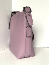 Load image into Gallery viewer, A dusty purple pebbled leather shoulder bag with a matching leather tag and silver hardware, photographed standing upright against a white background.