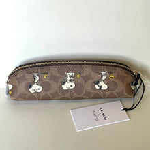 Load image into Gallery viewer, Coach x Peanuts pencil case with Snoopy woodstock design on a white background