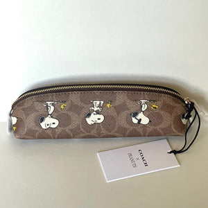 Coach x Peanuts pencil case with Snoopy woodstock design on a white background