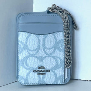 Light blue Coach wallet with chain detail on a white background