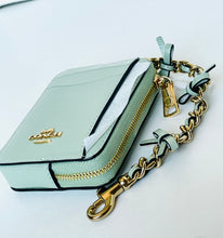 Load image into Gallery viewer, A Coach mini card holder in pale mint green leather with gold hardware, a gold-tone logo on the front, and a matching mint green leather chain strap with gold links.