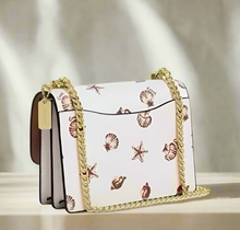 Load image into Gallery viewer, Handbag with shell pattern on a white background