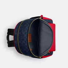Load image into Gallery viewer, Navy and red backpack with open front pocket on a light gray background