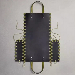 Black leather bag with green accents on a gray background