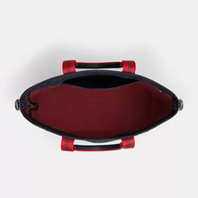 Load image into Gallery viewer, Black handbag with red accents on a white background