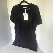 Load image into Gallery viewer, Black t-shirt with decorative studs on a hanger against a neutral background