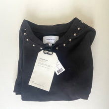 Load image into Gallery viewer, Folded black garment with studded details and tags on a white background