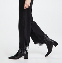 Load image into Gallery viewer, Person wearing black ankle boots and black pants on a white background