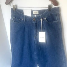 Load image into Gallery viewer, Blue jeans with a tag on a hanger against a white background