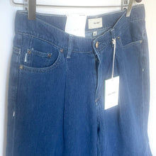 Load image into Gallery viewer, Blue jeans with tags on a white background