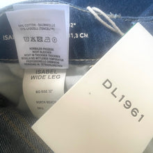 Load image into Gallery viewer, Close-up of denim jeans with label details and 'DL1961' branding.