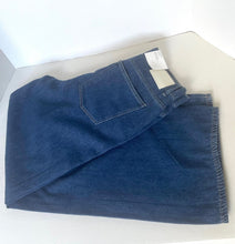Load image into Gallery viewer, Folded blue denim jacket on a white background