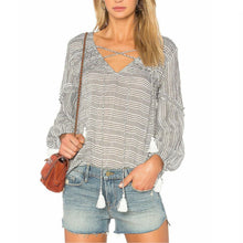 Load image into Gallery viewer, Woman wearing a patterned blouse and denim shorts with a brown leather bag on a white background