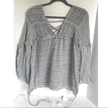 Load image into Gallery viewer, Black and white striped blouse on a hanger against a white background