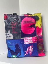 Load image into Gallery viewer, A square fabric pouch or bag featuring a vibrant collage print with various pop-culture and fashion images, including a lion, a woman, and text like 'LOVE MAKES NATURE VISIBLE' and 'LOVE LOVE LOVE'. The bag is photographed on a plain white surface, shown upside down.