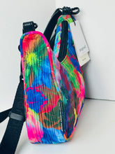 Load image into Gallery viewer, A small pleated crossbody bag with a vibrant multicolor tie-dye pattern, featuring black straps and a white hangtag with the brand name 'baggu'.