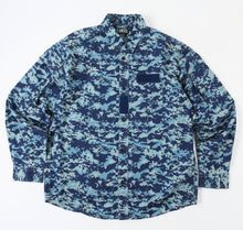 Load image into Gallery viewer, A long-sleeve button-up shirt by Diesel featuring a blue and light blue digital camouflage pattern, displayed flat against a white background with a black Diesel logo overlay at the top right.