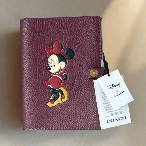Coach x Disney collaboration leather product with Minnie Mouse design and Coach tag.