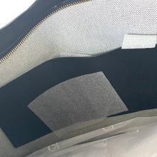 Load image into Gallery viewer, Close-up of a textured surface with a zipper and fabric details