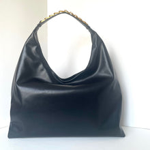 Load image into Gallery viewer, Black leather handbag with gold accents on a white background