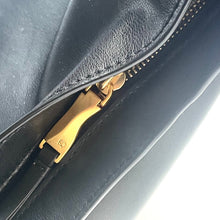 Load image into Gallery viewer, Close-up of a black leather bag with a gold zipper