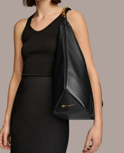 Load image into Gallery viewer, Person wearing a black dress with a matching black bag on a neutral background