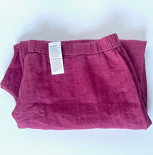 Load image into Gallery viewer, Folded pink skirt with a tag on a white background