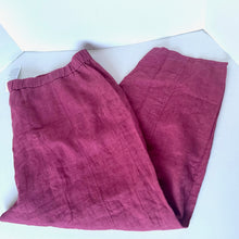 Load image into Gallery viewer, Folded pink pants on a white background