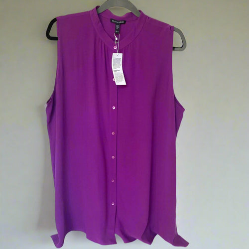 Purple sleeveless blouse on a hanger with a white background