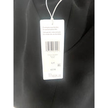 Load image into Gallery viewer, Black garment with a tag displaying text and a barcode on a white background