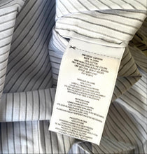 Load image into Gallery viewer, Close-up of striped fabric with a label on top