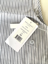 Load image into Gallery viewer, Striped shirt with a visible label on a white background