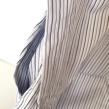 Load image into Gallery viewer, Close-up of a textured fabric with wavy lines in gray and white.