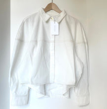 Load image into Gallery viewer, White jacket on a hanger against a white background