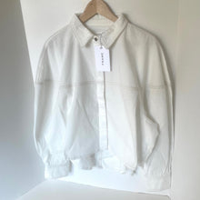 Load image into Gallery viewer, White denim jacket on a hanger with a visible brand tag against a white background