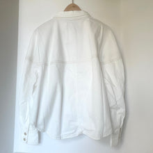 Load image into Gallery viewer, White denim jacket on a hanger against a white background