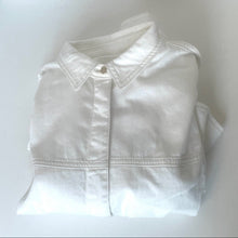 Load image into Gallery viewer, Folded white shirt on a light gray background