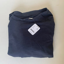 Load image into Gallery viewer, Folded navy blue shirt with a tag on a light beige background