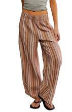 Load image into Gallery viewer, Striped pants worn by a person on a white background