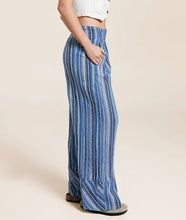 Load image into Gallery viewer, Blue striped pants worn by a person on a beige background