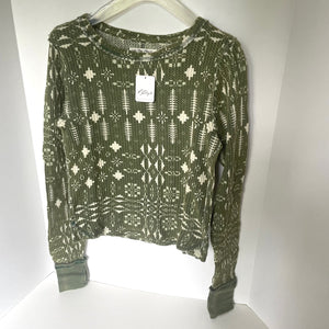 Green patterned sweater on a white background