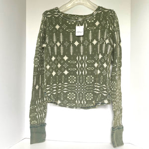 Green patterned long-sleeve top on a white background