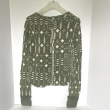 Load image into Gallery viewer, Green patterned shirt on a white background