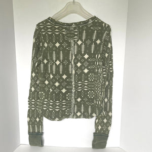 Green patterned shirt on a white background