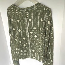 Load image into Gallery viewer, Green patterned sweater on a hanger against a white background